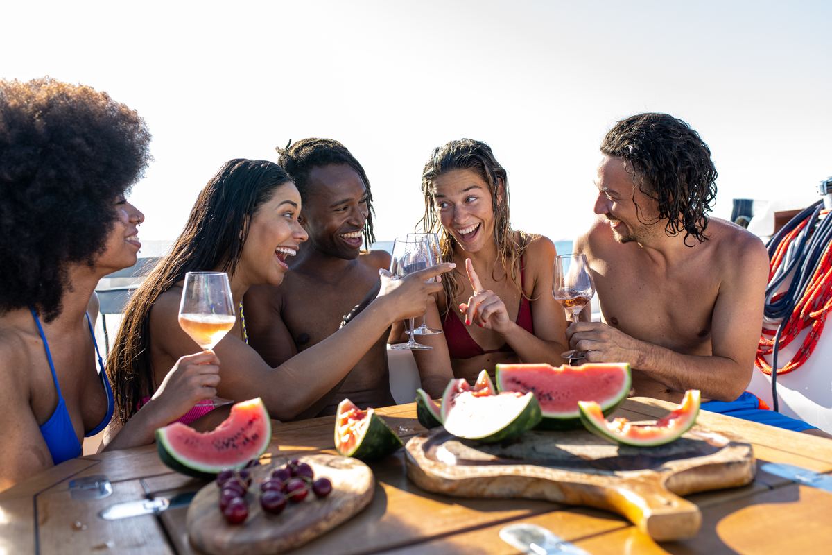 Friends toasting drinks at a boat party